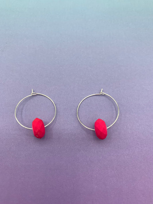 pink earrings. neon earrings. Neon pink faceted bead on silver plated hoops. hoop earrings.