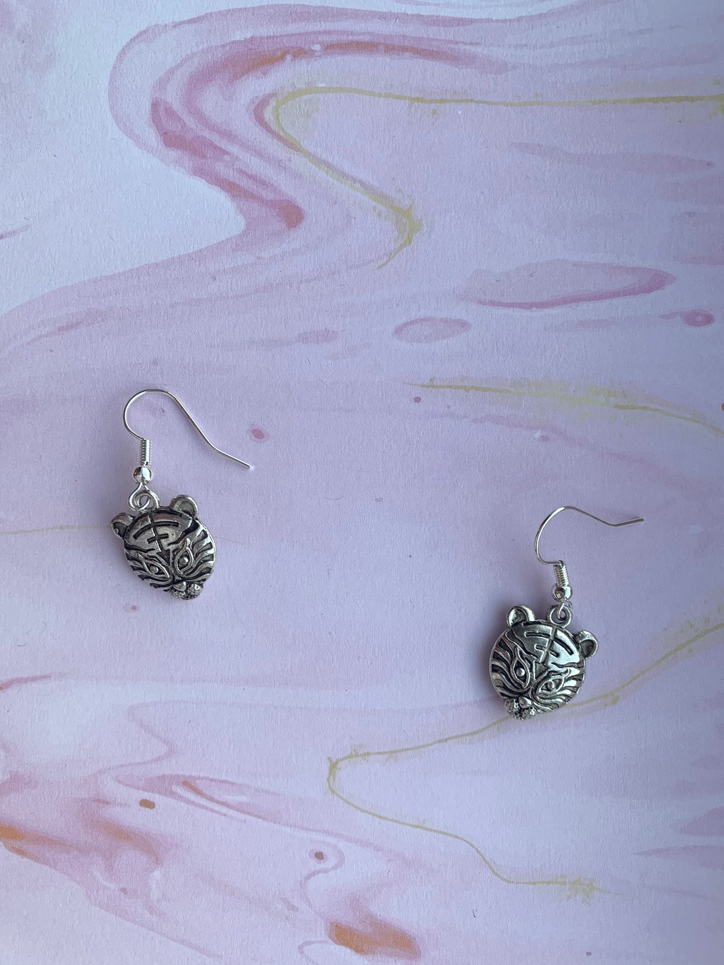 alloy silver coloured tiger face charms on silver plated hooks. animal earrings. carole baskin. tiger earrings. earring uk.