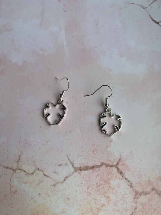 Tropical leaf outline in silver coloured alloy metal charm on silver plated hooks. Pretty earrings. Tropical earrings. Nature earrings.