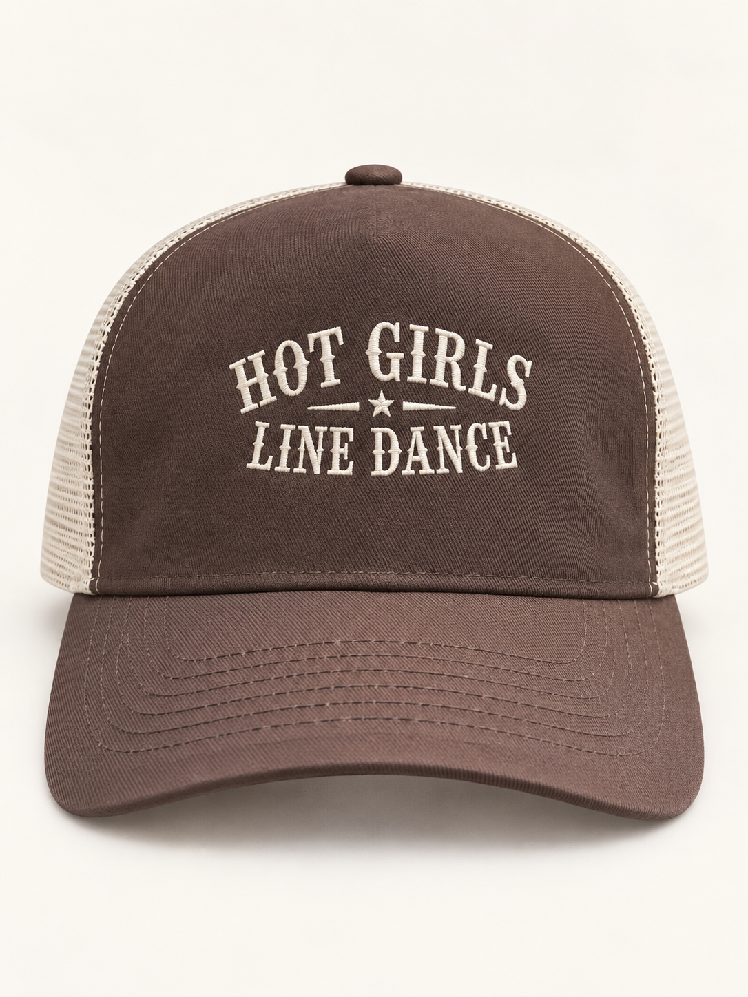 A brown and beige trucker hat with 'HOT GIRLS LINE DANCE' embroidered on the front, shown against a plain off-white background.
