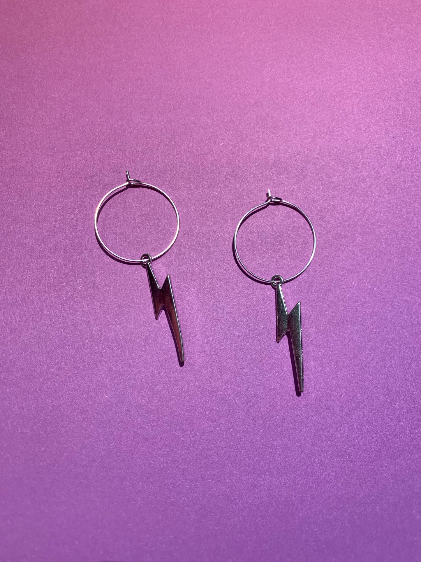 Lightning bolt earrings. Lightning bolt silver coloured alloy charm on silver plated hoops. bestselling earrings. fashion jewellery. funky earrings, hoop earrings. cheap earrings. 
